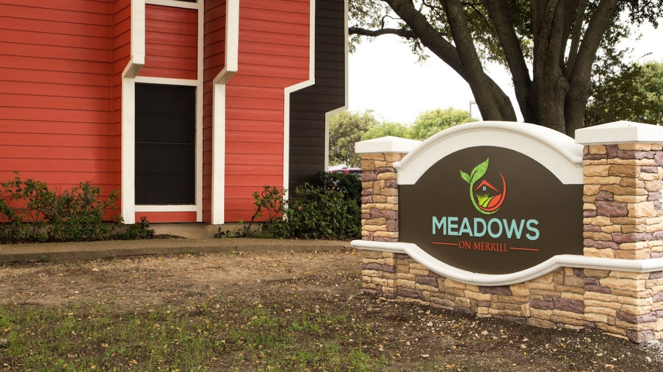 a sign for meadows is shown in front of a building at The Meadows on Merrill